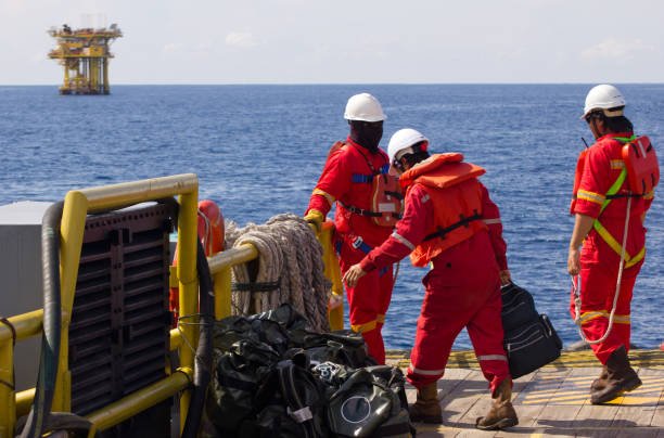 Rig workers being transported to an offshore vessel by boat, offshore Malaysia, South China Sea on October 31st, 2013